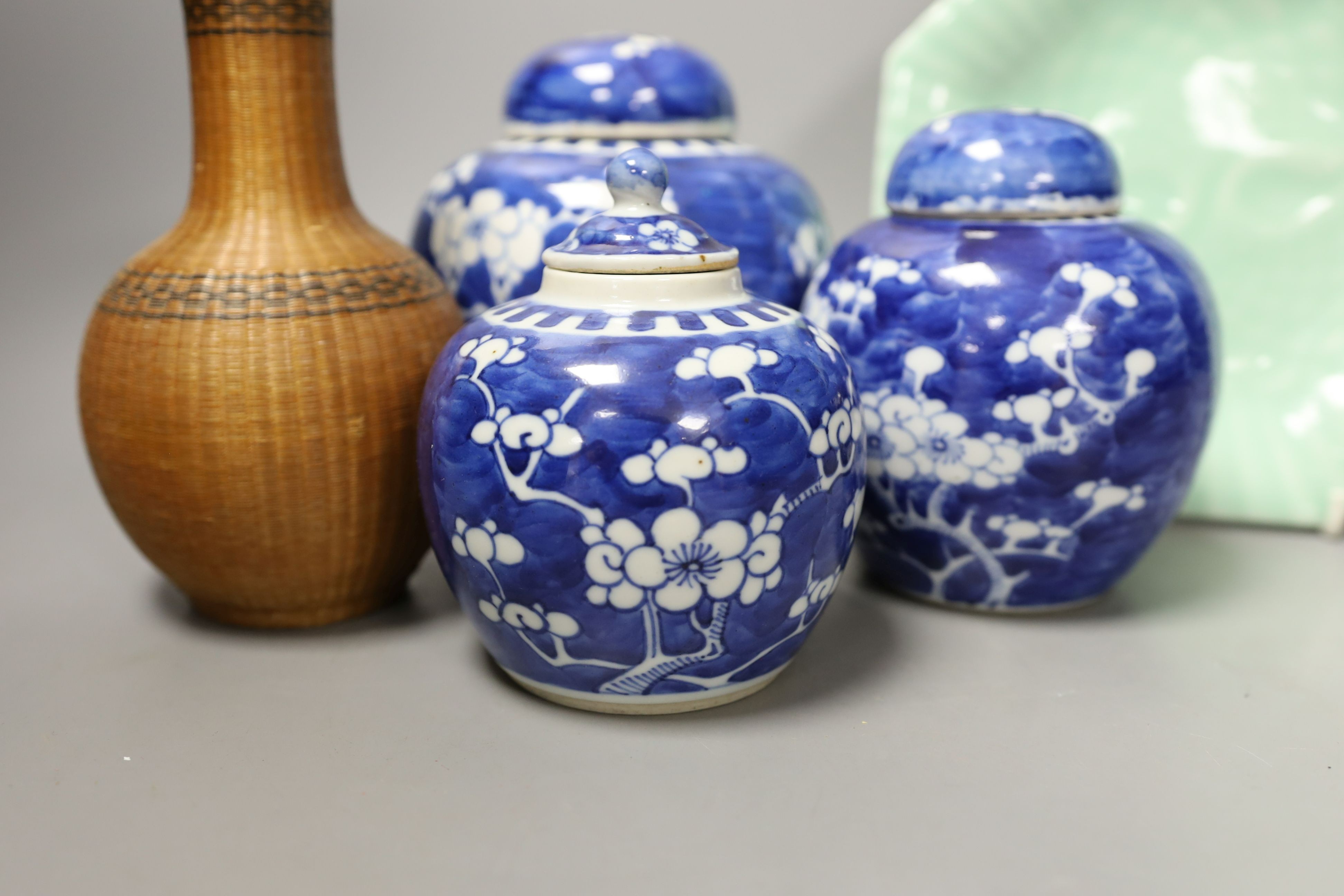 Three Chinese blue and white ginger jars and covers, a celadon plate and bamboo covered vase (5)